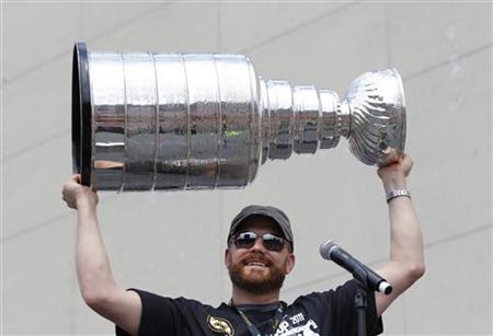 Boston Bruins goaltender Tim Thomas hoists the Stanley Cup during the Bruins' NHL victory parade through the streets of Boston Boston Bruins goaltender Tim Thomas hoists the Stanley Cup during the Bruins' NHL victory parade through the streets of Boston