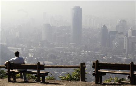 A resident sits at San Cristobal hill in front of the Chilean capital under a heavy layer of smog A resident sits at San Cristobal hill in front of the Chilean capital under a heavy layer of smog