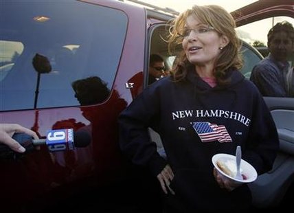 Former Alaska Governor Sarah Palin, wearing a New Hampshire sweatshirt, talks to reporters following a stop at a clam bake at a private resi Former Alaska Governor Sarah Palin, wearing a New Hampshire sweatshirt, talks to reporters following a stop at a clam bake at a private resi
