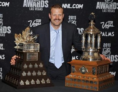 Boston Bruins' Tim Thomas poses with the Conn Smythe Trophy and the Vezina Trophy at the 2011 NHL Awards in Las Vegas. Boston Bruins' Tim Thomas poses with the Conn Smythe Trophy and the Vezina Trophy at the 2011 NHL Awards in Las Vegas.