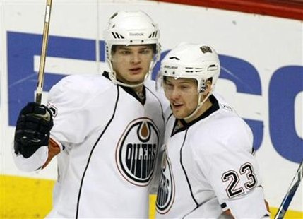 Edmonton Oilers Teemu Hartikainen celebrates with teammate winger Linus Omark who got the assist after Hartikainen scored a goal against the Edmonton Oilers Teemu Hartikainen celebrates with teammate winger Linus Omark who got the assist after Hartikainen scored a goal against the
