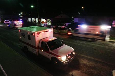Ambulances line the street as they wait to be dispatched to areas in Joplin after a tornado hit the town