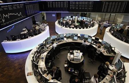 Traders are pictured at their desks in front of the DAX board at the Frankfurt stock exchange Traders are pictured at their desks in front of the DAX board at the Frankfurt stock exchange