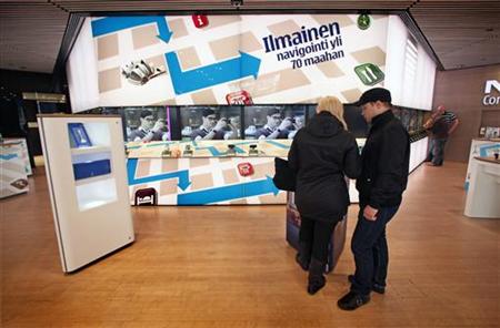 Customers look over a mobile phone display at the Nokia flagship store in Helsinki Customers look over a mobile phone display at the Nokia flagship store in Helsinki