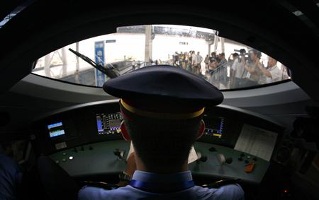 A train driver prepares to depart the Beijing-South railway station for Shanghai in a new high-speed train as part of an official trip for m