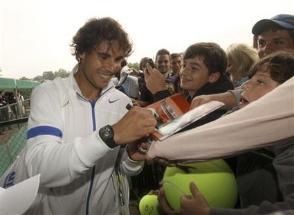 Rafael Nadal of Spain signs autographs as he leaves a practise court at the Wimbledon tennis championships in London Rafael Nadal of Spain signs autographs as he leaves a practise court at the Wimbledon tennis championships in London