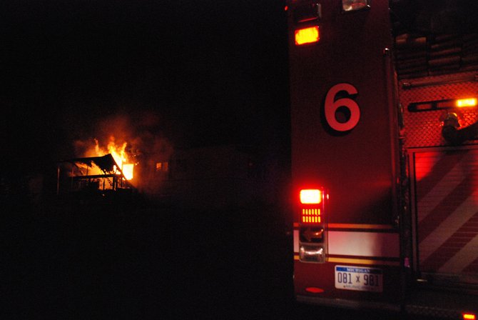 A trailer in Kalamazoo is fully engulfed in flames - a passing motorist helped everyone escape unharmed. Photos by Sean Patrick Duross.