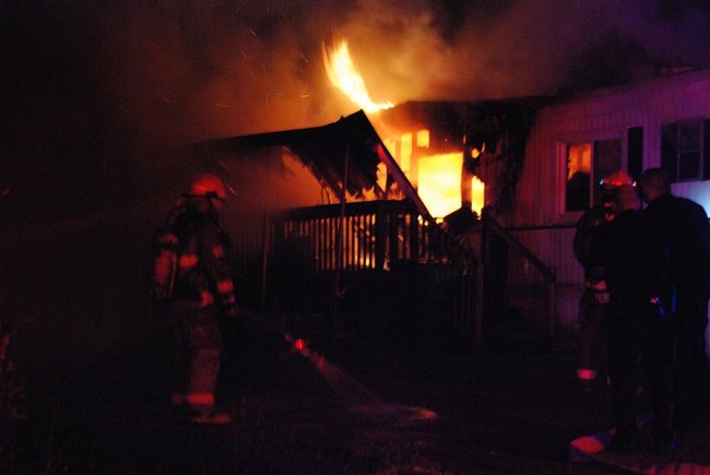 A trailer in Kalamazoo is fully engulfed in flames - a passing motorist helped everyone escape unharmed. Photos by Sean Patrick Duross.