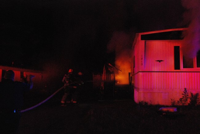 A trailer in Kalamazoo is fully engulfed in flames - a passing motorist helped everyone escape unharmed. Photos by Sean Patrick Duross.
