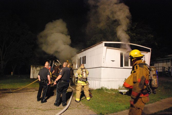 A trailer in Kalamazoo is fully engulfed in flames - a passing motorist helped everyone escape unharmed. Photos by Sean Patrick Duross.