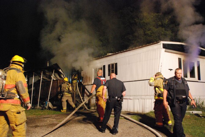 A trailer in Kalamazoo is fully engulfed in flames - a passing motorist helped everyone escape unharmed. Photos by Sean Patrick Duross.