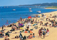 Beachgoers on the shores of Lake Michigan in Saugatuck, Michigan.