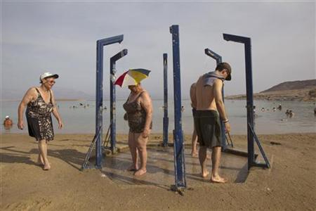 Tourists take a shower after bathing in the Dead Sea resort of Ein Bokeq Tourists take a shower after bathing in the Dead Sea resort of Ein Bokeq