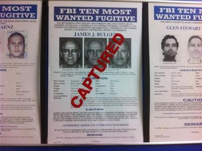 A most wanted poster for FBI Most Wanted fugitive and accused Boston crime boss Bulger is seen stamped CAPTURED at FBI headquarters