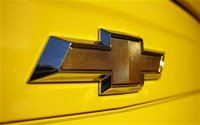 A Chevrolet logo is displayed on a vehicle at Courtesy Chevrolet dealership in Phoenix