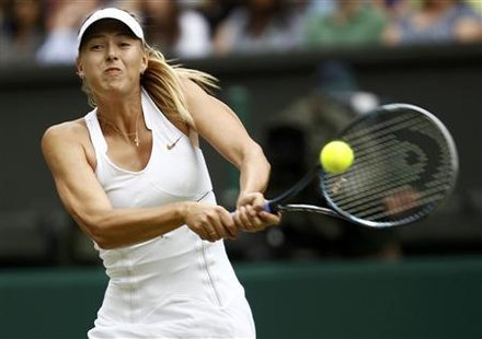 Maria Sharapova of Russia hits a return to Sabine Lisicki of Germany during their semi-final match at the Wimbledon tennis championships in Maria Sharapova of Russia hits a return to Sabine Lisicki of Germany during their semi-final match at the Wimbledon tennis championships in