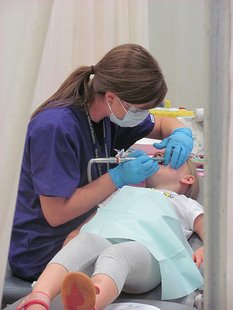 A volunteer provides dental care at the Mission of Mercy clinic in Weston, WI A volunteer provides dental care at the Mission of Mercy clinic in Weston, WI