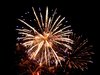 Fireworks explosions litter the sky. 