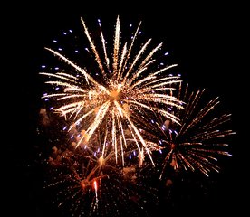 Fireworks explosions litter the sky. 