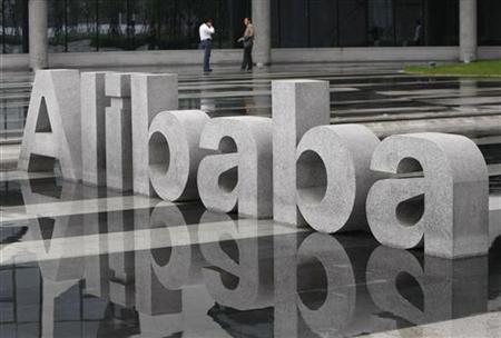 Two men chat beside a logo of Alibaba (China) Technology Co. Ltd at its headquarters on the outskirts of Hangzhou Two men chat beside a logo of Alibaba (China) Technology Co. Ltd at its headquarters on the outskirts of Hangzhou