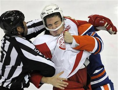 Detroit Red Wings' Jonathan Ericsson is punched by Edmonton Oilers' Gilbert Brule during the second period of their NHL hockey game in Edmon Detroit Red Wings' Jonathan Ericsson is punched by Edmonton Oilers' Gilbert Brule during the second period of their NHL hockey game in Edmon