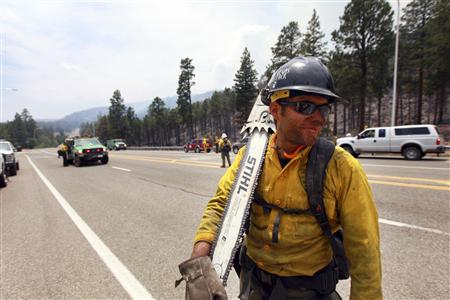 A fire crew member is seen as fire crews are deployed in order to attack hotspots from the Las Conchas wildfire near Los Alamos, New Mexico A fire crew member is seen as fire crews are deployed in order to attack hotspots from the Las Conchas wildfire near Los Alamos, New Mexico