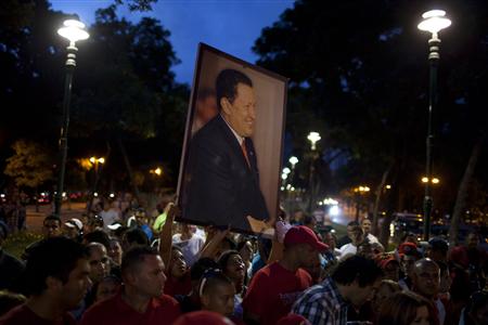 Supporters of Venezuelan President Hugo Chavez holding a picture of him take part in a rally in Caracas Supporters of Venezuelan President Hugo Chavez holding a picture of him take part in a rally in Caracas