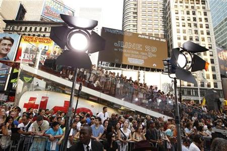A crowd gathers in Times Square to watch celebrities arrive during the premiere of "Transformers: Dark of The Moon" in New York A crowd gathers in Times Square to watch celebrities arrive during the premiere of "Transformers: Dark of The Moon" in New York