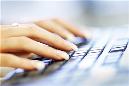 A woman uses a computer keyboard in this photo illustration taken in Sydney A woman uses a computer keyboard in this photo illustration taken in Sydney