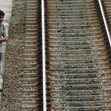 A man waits for a commuter train in Colombo
