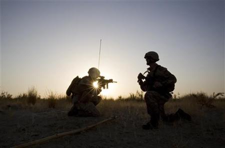 U.S. Marines are silhouetted against sunset during a join patrol with Afghan National Army soldiers along Helmand river near the Camp Gorgak U.S. Marines are silhouetted against sunset during a join patrol with Afghan National Army soldiers along Helmand river near the Camp Gorgak