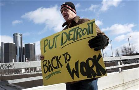 Unemployed worker Pollock carries a sign outside Cobo Center to demonstrate for jobs and good wages before start of press days at North Amer Unemployed worker Pollock carries a sign outside Cobo Center to demonstrate for jobs and good wages before start of press days at North Amer