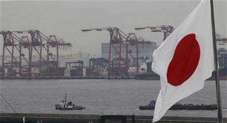 A Japanese national flag is seen in front of cargo cranes at an industrial port in Tokyo A Japanese national flag is seen in front of cargo cranes at an industrial port in Tokyo