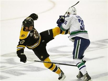 Vancouver Canucks' Jannik Hansen checks Boston Bruins' Tomas Kaberle during the first period in Game 3 of the Stanley Cup hockey playoff in Vancouver Canucks' Jannik Hansen checks Boston Bruins' Tomas Kaberle during the first period in Game 3 of the Stanley Cup hockey playoff in