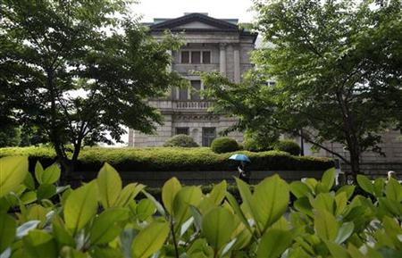 A woman walks past the Bank of Japan building in Tokyo A woman walks past the Bank of Japan building in Tokyo