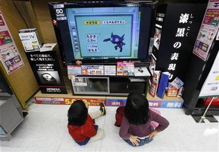 Children sit on the floor as they watch Hitachi's television at an electronics shop in Tokyo Children sit on the floor as they watch Hitachi's television at an electronics shop in Tokyo