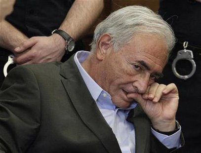 Former IMF chief Dominique Strauss-Kahn listens to his lawyer, Williams Taylor, inside of a New York State Supreme Courthouse during a bail Former IMF chief Dominique Strauss-Kahn listens to his lawyer, Williams Taylor, inside of a New York State Supreme Courthouse during a bail