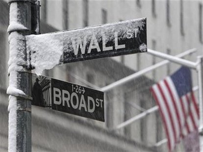 Snow covers a street sign at the corner of Wall St. and Broad St. in New York's financial district Snow covers a street sign at the corner of Wall St. and Broad St. in New York's financial district