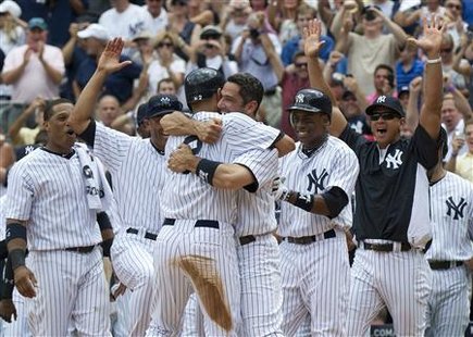 New York Yankees Jorge Posada hugs Derek Jeter after Jeter hit a solo home run and his 3000th career hit against the Tampa Bay Rays in New Y New York Yankees Jorge Posada hugs Derek Jeter after Jeter hit a solo home run and his 3000th career hit against the Tampa Bay Rays in New Y