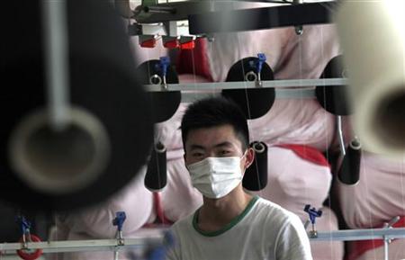 An employee works at the Yiwu Lianfa clothing factory in Yiwu, Zhejiang province An employee works at the Yiwu Lianfa clothing factory in Yiwu, Zhejiang province