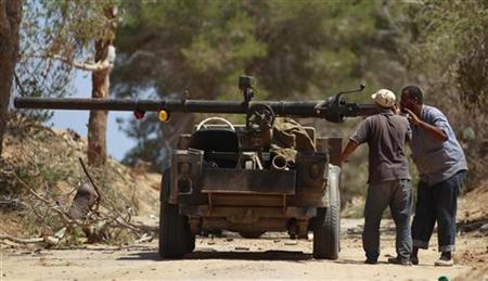 Rebel fighters load their vehicle-mounted weapon on the outskirts of Zlitan, near Misrata's western frontline Rebel fighters load their vehicle-mounted weapon on the outskirts of Zlitan, near Misrata's western frontline
