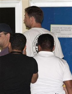 Mexican police escort Beresford-Redman, former producer of "Survivor" television series, inside Quintana Roo's attorney general's office in Mexican police escort Beresford-Redman, former producer of "Survivor" television series, inside Quintana Roo's attorney general's office in