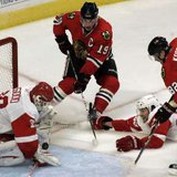 Detroit Red Wings goaltender Chris Osgood (L) makes a point-blank save on Chicago Blackhawks center Jonathan Toews (2nd L) while Red Wings defenseman Brad Stuart (2nd R) and Blackhawks winger Tomas Kopecky close in during the third period of their NHL hockey game in Chicago October 9, 2010. REUTERS Detroit Red Wings goaltender Chris Osgood (L) makes a point-blank save on Chicago Blackhawks center Jonathan Toews (2nd L) while Red Wings defenseman Brad Stuart (2nd R) and Blackhawks winger Tomas Kopecky close in during the third period of their NHL hockey game in Chicago October 9, 2010. REUTERS
