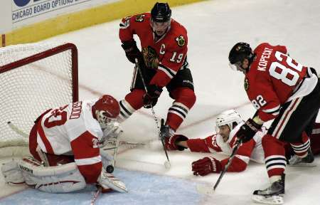 Detroit Red Wings goaltender Chris Osgood (L) makes a point-blank save on Chicago Blackhawks center Jonathan Toews (2nd L) while Red Wings defenseman Brad Stuart (2nd R) and Blackhawks winger Tomas Kopecky close in during the third period of their NHL hockey game in Chicago October 9, 2010. REUTERS Detroit Red Wings goaltender Chris Osgood (L) makes a point-blank save on Chicago Blackhawks center Jonathan Toews (2nd L) while Red Wings defenseman Brad Stuart (2nd R) and Blackhawks winger Tomas Kopecky close in during the third period of their NHL hockey game in Chicago October 9, 2010. REUTERS
