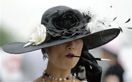 A woman smokes a cigarette at Churchill Downs in Louisville A woman smokes a cigarette at Churchill Downs in Louisville