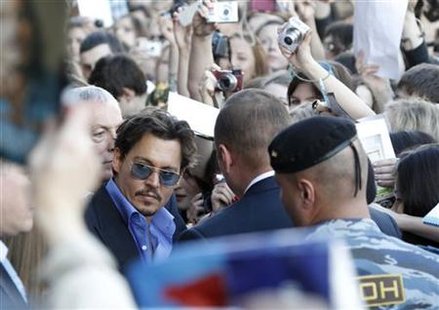 Actor Depp is surrounded by fans and security after arriving for the premiere of his new film "Pirates of the Caribbean:On Stranger Tides" a Actor Depp is surrounded by fans and security after arriving for the premiere of his new film "Pirates of the Caribbean:On Stranger Tides" a