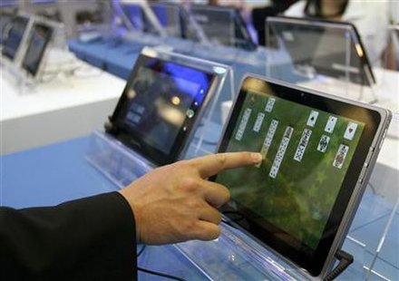 A visitor plays with a tablet PC at the Intel booth during the Computex 2011 computer fair at the TWTC Nangang exhibition hall in Taipei A visitor plays with a tablet PC at the Intel booth during the Computex 2011 computer fair at the TWTC Nangang exhibition hall in Taipei