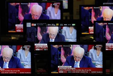 News Corp Chairman and Chief Executive Rupert Murdoch is seen on television screens in an electrical store as he is questioned by a parliame News Corp Chairman and Chief Executive Rupert Murdoch is seen on television screens in an electrical store as he is questioned by a parliame