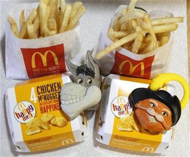 Two McDonald's Happy Meal with toy watches fashioned after the characters Donkey and Puss in Boots from the movie "Shrek Forever After" are Two McDonald's Happy Meal with toy watches fashioned after the characters Donkey and Puss in Boots from the movie "Shrek Forever After" are