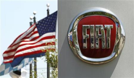 A U.S. flag flutters in the wind behind a Fiat logo at a car dealership in Alexandria A U.S. flag flutters in the wind behind a Fiat logo at a car dealership in Alexandria